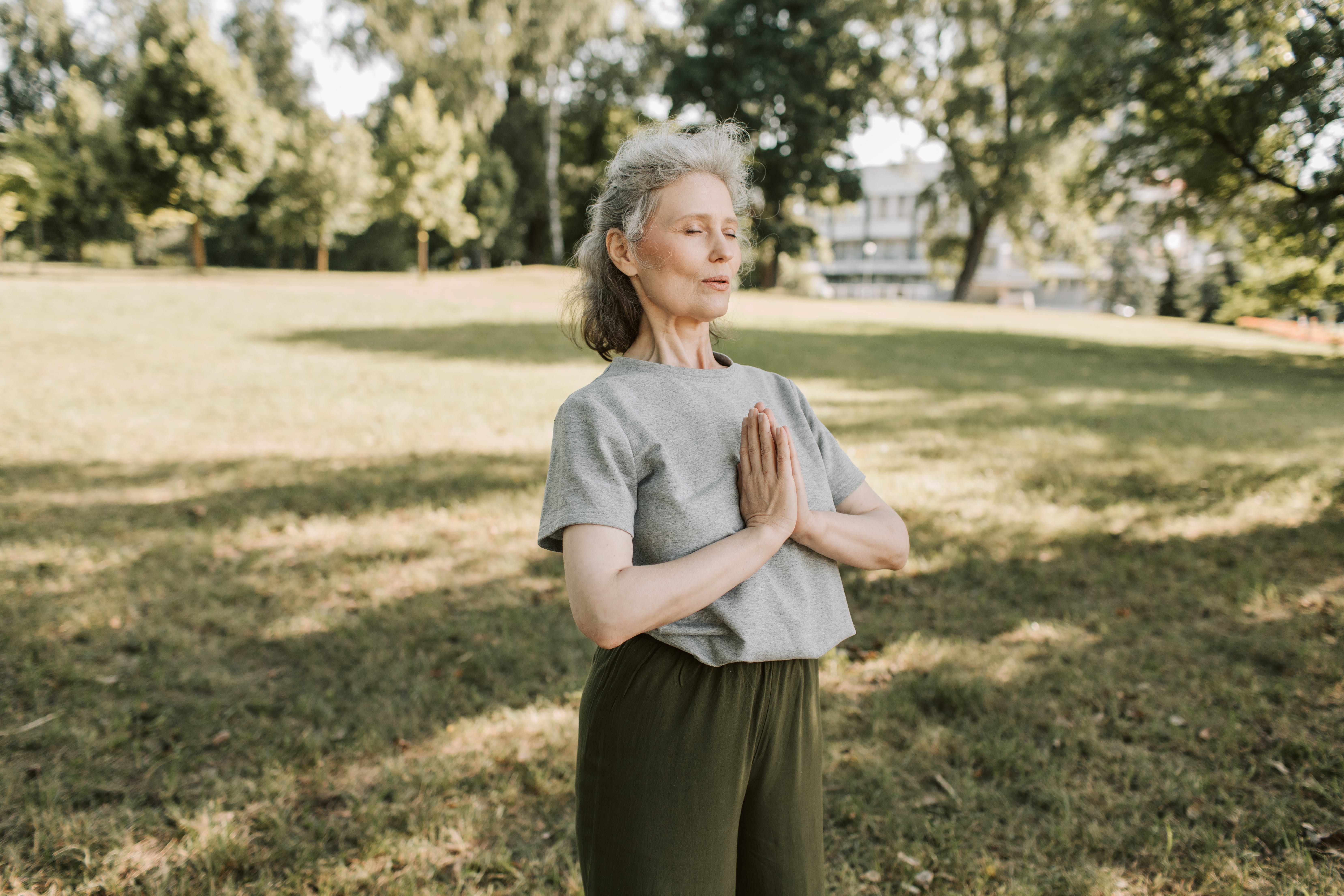 Woman in a park meditating.